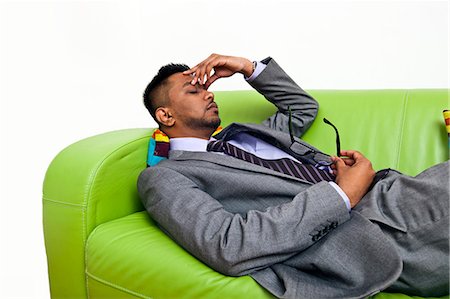 Stressed business man holding the bridge of his nose Stock Photo - Premium Royalty-Free, Code: 693-06967502