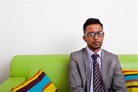 stock market crash - Businessman sitting on sofa looking at camera Stock Photo - Premium Royalty-Free, Code: 693-06967503