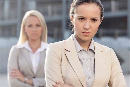 personal - Portrait of serious young businesswoman with female colleague in background Stockbilder - Premium RF Lizenzfrei, Bildnummer: 693-07444467