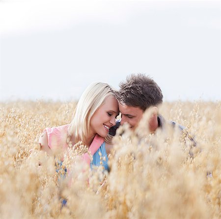 pictures of a man growing crops in the field - Romantic young couple sitting amidst field Stock Photo - Premium Royalty-Free, Code: 693-07444501