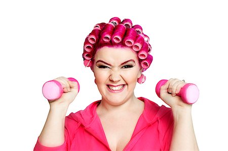 Portrait of a young woman happily lifting weights Foto de stock - Sin royalties Premium, Código: 693-07444558