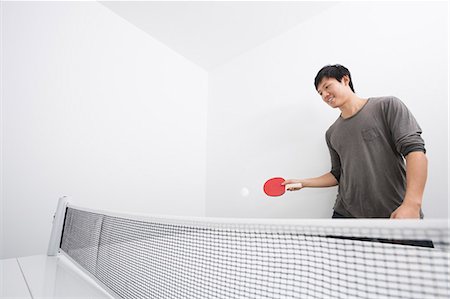 sports playing - Asian mid adult man playing ping-pong Stock Photo - Premium Royalty-Free, Code: 693-07455928