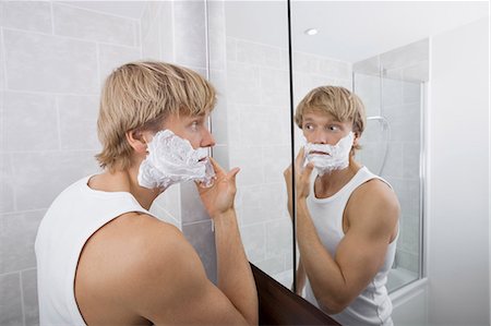 simsearch:693-06019176,k - Mid-adult man applying shaving cream in bathroom Stock Photo - Premium Royalty-Free, Code: 693-07456066