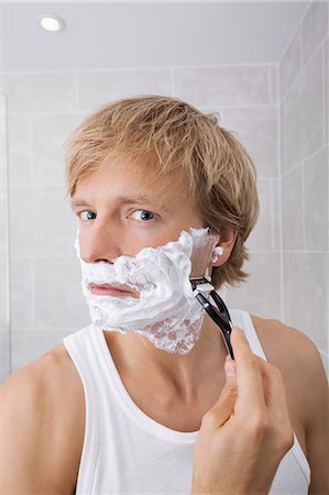 simsearch:632-03027414,k - Portrait of mid-adult man shaving in bathroom Stock Photo - Premium Royalty-Free, Code: 693-07456067