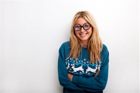 sweaters - Portrait of happy woman wearing eyeglasses against white background Stock Photo - Premium Royalty-Free, Code: 693-07456115