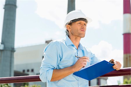 engineer works - Male architect with clipboard and pen at site Stock Photo - Premium Royalty-Free, Code: 693-07456120