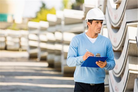 engineers inspecting at construction site - Male supervisor with clipboard inspecting stock at site Stock Photo - Premium Royalty-Free, Code: 693-07456134