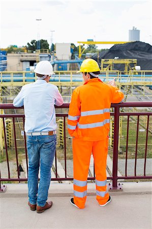 Back view of architects standing against railing at construction site Stock Photo - Premium Royalty-Free, Code: 693-07456153