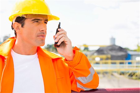 simsearch:693-07456156,k - Male construction worker communicating on walkie-talkie at site Foto de stock - Sin royalties Premium, Código: 693-07456180