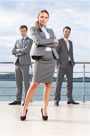 Full length portrait of confident businesswoman standing with coworkers on terrace against sky Stock Photo - Premium Royalty-Free, Code: 693-07456198