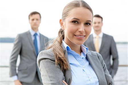 damenanzug - Portrait of confident businesswoman standing with coworkers on terrace Stockbilder - Premium RF Lizenzfrei, Bildnummer: 693-07456241