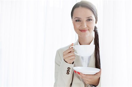 simsearch:693-07456264,k - Portrait of businesswoman having coffee in office Stock Photo - Premium Royalty-Free, Code: 693-07456264