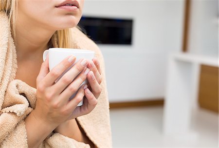 suffering - Midsection of young woman holding coffee mug in house Stock Photo - Premium Royalty-Free, Code: 693-07456372