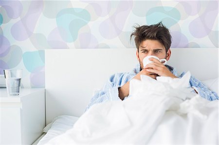 sick people in bed - Sick man having coffee in bed Stock Photo - Premium Royalty-Free, Code: 693-07456411