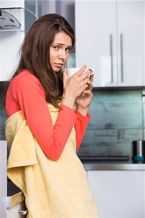 simsearch:693-07456390,k - Portrait of ill woman having coffee in kitchen Stock Photo - Premium Royalty-Free, Code: 693-07456421