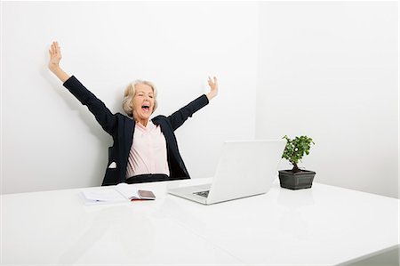 Senior businesswoman yawning while looking at laptop in office Stock Photo - Premium Royalty-Free, Code: 693-07456467