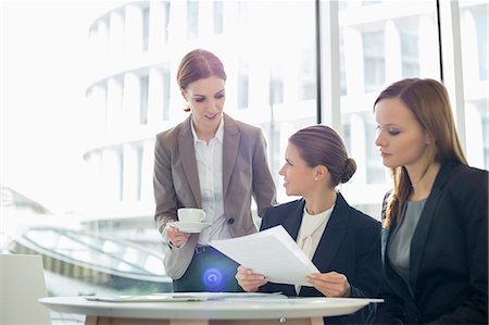 simsearch:693-07456264,k - Businesswomen with paperwork during coffee break Stock Photo - Premium Royalty-Free, Code: 693-07542135