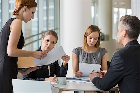 Business people doing paperwork in office cafeteria Stock Photo - Premium Royalty-Free, Code: 693-07542140