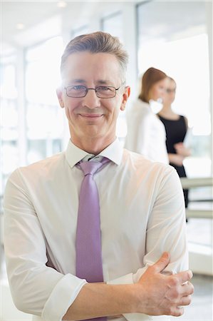 professionell - Portrait of confident businessman standing arms crossed in office Stock Photo - Premium Royalty-Free, Code: 693-07542156