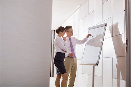 flip chart - Business colleagues planning for presentation in office Stock Photo - Premium Royalty-Free, Code: 693-07542177