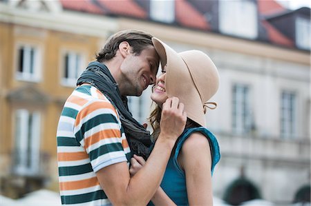 simsearch:693-07542204,k - Romantic young man kissing woman against buildings Stock Photo - Premium Royalty-Free, Code: 693-07542196