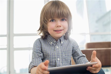 simsearch:693-07542248,k - Portrait of cute boy holding tablet computer at home Stock Photo - Premium Royalty-Free, Code: 693-07542235