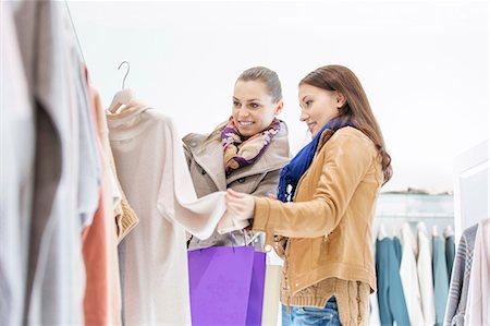 shopping not illustration - Young female friends choosing sweater in store Stock Photo - Premium Royalty-Free, Code: 693-07542319