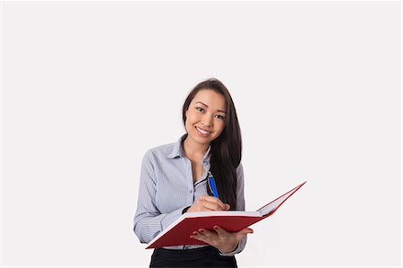 silhouette of teenage girl - Portrait of happy businesswoman with book and pen over white background Stock Photo - Premium Royalty-Free, Code: 693-07542364