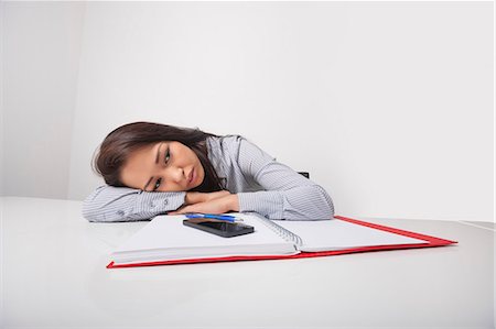 desk with wall - Exhausted businesswoman leaning at office desk Photographie de stock - Premium Libres de Droits, Code: 693-07542361