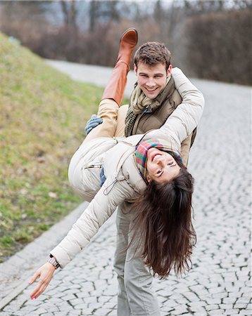 simsearch:693-07672886,k - Portrait of happy man carrying woman in park Stock Photo - Premium Royalty-Free, Code: 693-07672568