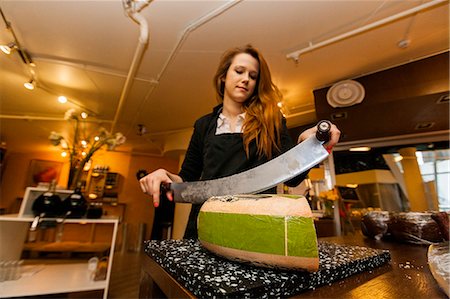 Female salesperson cutting cheese at store Stockbilder - Premium RF Lizenzfrei, Bildnummer: 693-07672595