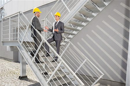 Full length of young male architects discussing on steps Stock Photo - Premium Royalty-Free, Code: 693-07672622