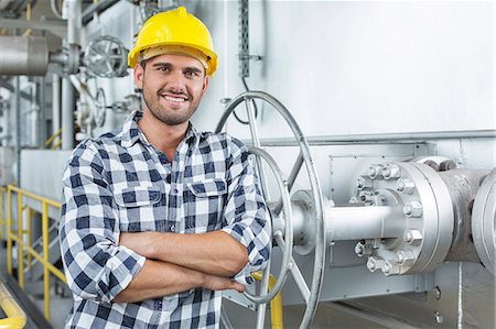 plant people safety - Young male worker standing arms crossed in industry Stock Photo - Premium Royalty-Free, Code: 693-07672630