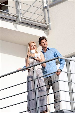 simsearch:693-07672655,k - Smiling young man with woman having coffee at hotel balcony Stock Photo - Premium Royalty-Free, Code: 693-07672657