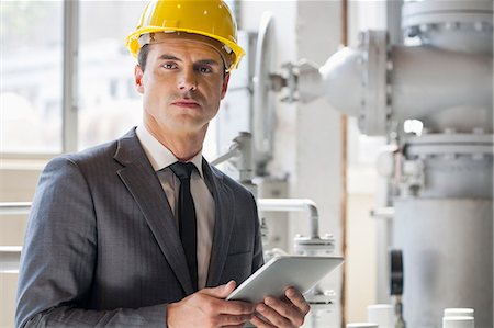 Portrait of young male architect holding tablet computer in industry Stock Photo - Premium Royalty-Free, Code: 693-07672650