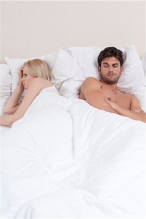 quarrel couple - Young couple avoiding each other in bed Stock Photo - Premium Royalty-Free, Code: 693-07672710