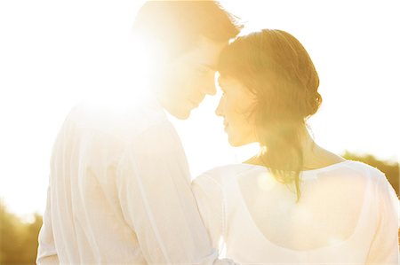 sun light people - Rear view of romantic couple looking at each other during summer Stock Photo - Premium Royalty-Free, Code: 693-07672759