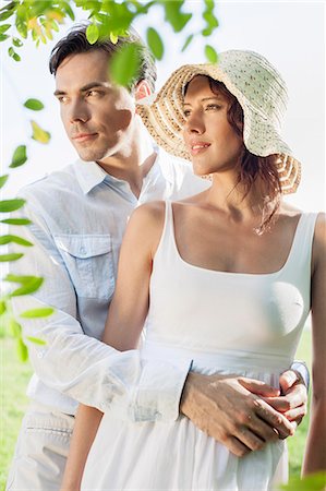 Loving young couple looking away in park Stock Photo - Premium Royalty-Free, Code: 693-07672776