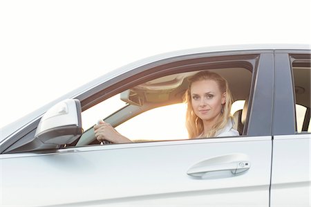 Portrait of beautiful woman driving car Stock Photo - Premium Royalty-Free, Code: 693-07672874