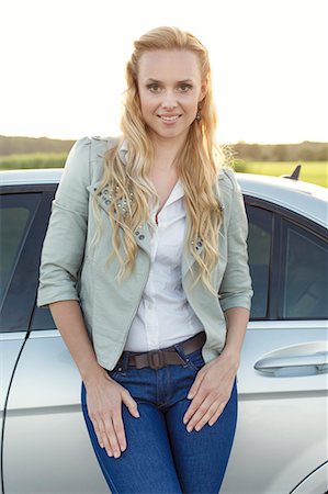 simsearch:693-07672829,k - Portrait of attractive young woman standing by car at countryside Stock Photo - Premium Royalty-Free, Code: 693-07672871