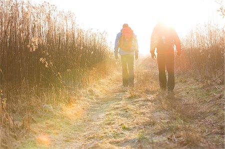 simsearch:693-07672993,k - Full length rear view of male hikers walking together in field Foto de stock - Sin royalties Premium, Código: 693-07673013