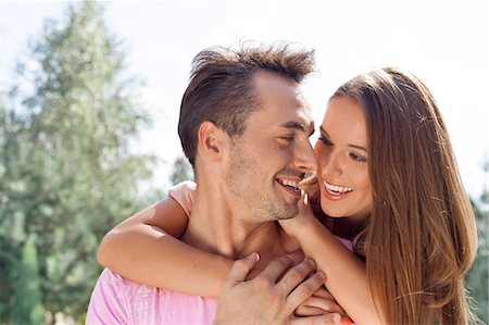 Smiling young couple looking at each other in park Stock Photo - Premium Royalty-Free, Code: 693-07673022