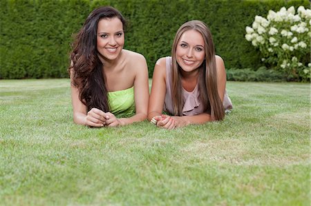 simsearch:693-07672803,k - Portrait of beautiful young women with long hair lying in park Stock Photo - Premium Royalty-Free, Code: 693-07673057