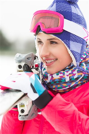 ski goggles person - Beautiful young woman carrying skis outdoors Stock Photo - Premium Royalty-Free, Code: 693-07673108