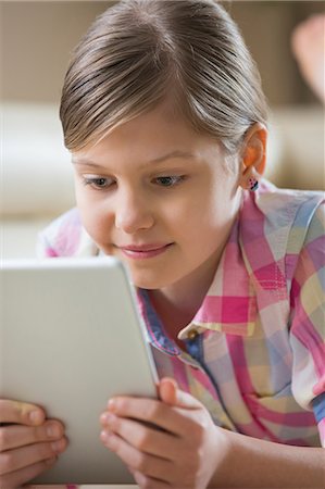 simsearch:693-07673302,k - Close-up of girl using digital tablet at home Stock Photo - Premium Royalty-Free, Code: 693-07673248