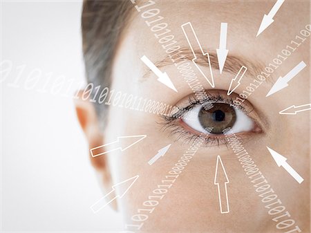 Close-up portrait of businesswoman with binary digits and arrow signs moving towards her eye against white background Photographie de stock - Premium Libres de Droits, Code: 693-07673289