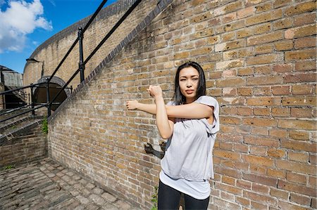 simsearch:693-07912090,k - Beautiful fit woman exercising against brick wall Stockbilder - Premium RF Lizenzfrei, Bildnummer: 693-07912075