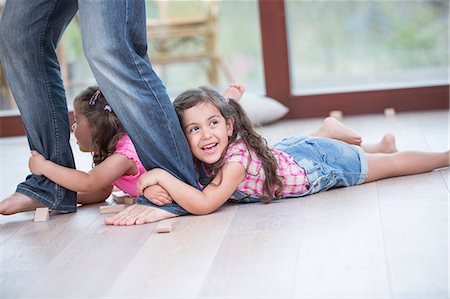 families, generations - Low section of father dragging girls on hardwood floor Stock Photo - Premium Royalty-Free, Code: 693-07912140