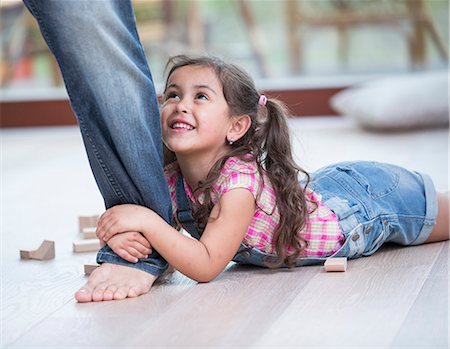 simsearch:693-07912136,k - Low section of father dragging girl on hardwood floor Stock Photo - Premium Royalty-Free, Code: 693-07912141