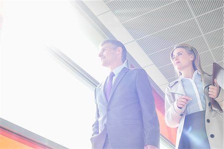 simsearch:693-07912282,k - Low angle view of business people walking in railroad station Stock Photo - Premium Royalty-Free, Code: 693-07912293